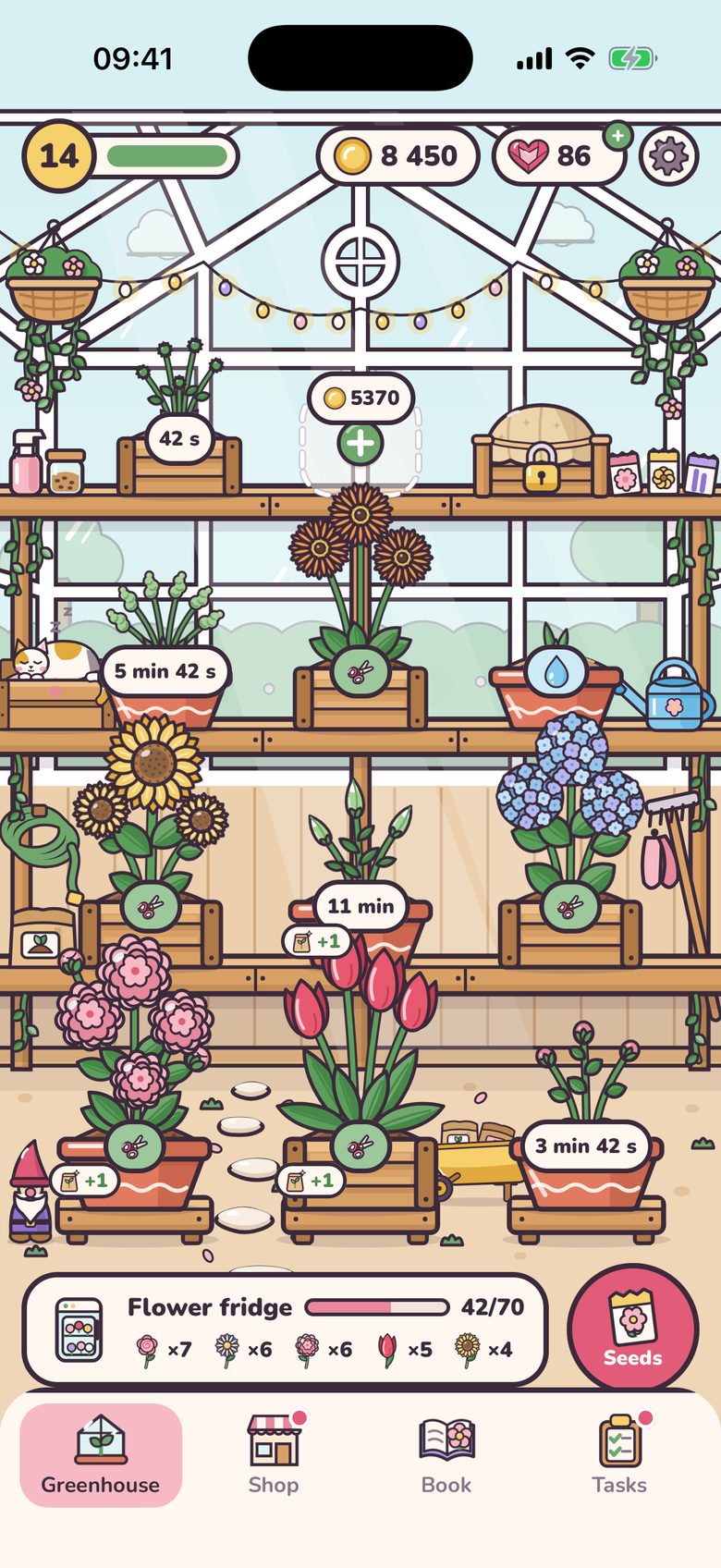 The greenhouse: wooden shelves of pots with sunflowers, tulips, hydrangeas and other flowers in bloom, seedlings with timers, and one pot asking for water. A garden gnome stands below and a cat sleeps on a shelf. At the bottom, the flower fridge holds the cut stems, next to the Seeds button.